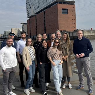 Kordiam team in Hamburg in front of the harbor and Elbephilharmonie.